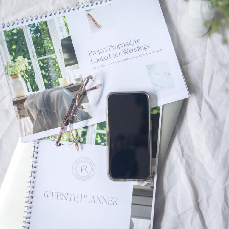 Mobile phone on the desk with web design proposals